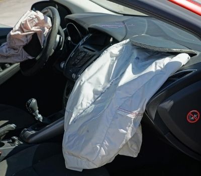showing deployed airbag of a car